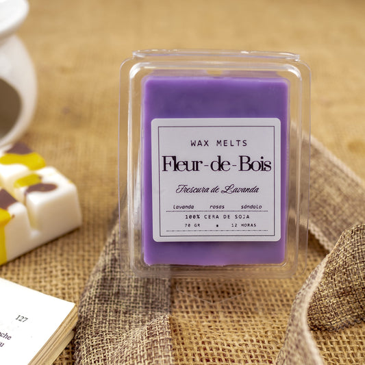 Primer plano de un paquete de Fleur-de-Bois Wax Melts Barra de chocolate FRESCURA DE LAVANDA, hechos a mano con cera de soja, con aromas de lavanda, rosa y sándalo, sobre arpillera y fondo desenfocado.
